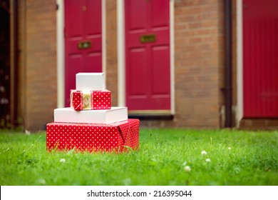 Christmas gift boxes delivered to house front door in summer. Early Christmas preparation concept. 