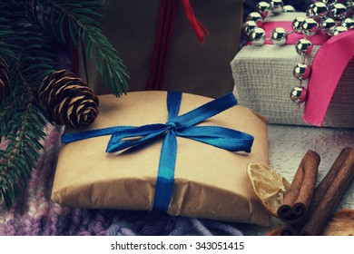 Christmas gift boxes, fir tree branch and winter scarf