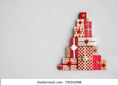 Christmas gift boxes laid out in the shape of a Christmas tree, overhead view