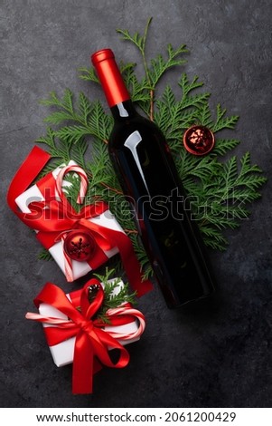 Christmas gift boxes and wine bottle. Top view flat lay