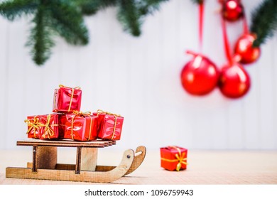 christmas gift boxes and xmas sleigh on wooden table over blurred background with christmas balls and - Decorative Christmas Sleigh Sale christmas gift boxes and xmas sleigh on wooden table over blurred background with christmas balls and - Decorative Christmas Sleigh Sale