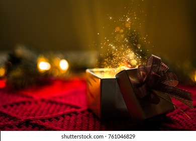 Christmas Gift With Gold Particles Magic Lights.