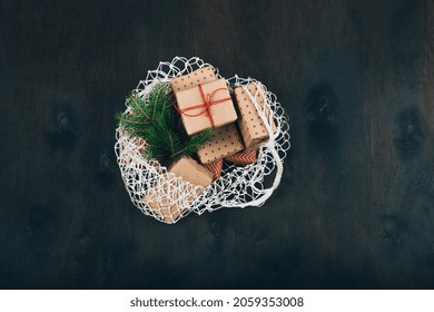 Christmas gift in a Reusable bag. Eco friendly mesh net shopping bag with craft gift boxes. Flat lay, top view. High quality photo - Powered by Shutterstock