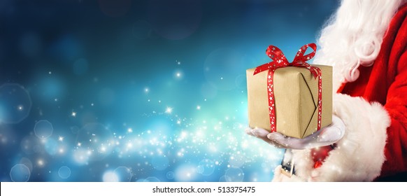 Christmas Gift - Santa Claus Giving Gift Box In Magic Night
