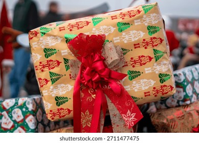 Christmas gift wrapped in nutcracker patterned paper with a ribbon displayed as decoration during a festive holiday motorcycle parade