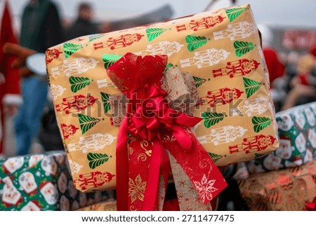 Christmas gift wrapped in nutcracker patterned paper with a ribbon displayed as decoration during a festive holiday motorcycle parade