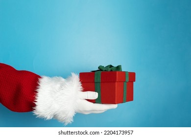 Christmas Gift Wrapping, Santa's Hand Holding A Gift Box