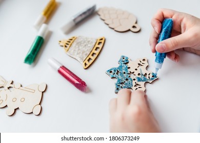 Christmas gifts. handmade Wooden toys.Making New Year decoration. Christmas ornaments. little child making Christmas decoration ornament .concept of creativity, handwork, preparation for the holiday. - Powered by Shutterstock