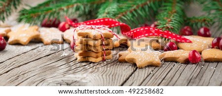 Christmas Gingerbread Cookies Star Shape in Stack. Holiday concept decorated with Fir Tree and Cranberry. Selective focus, Long web format
