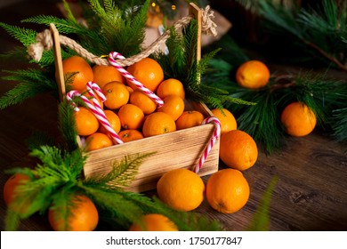 Christmas gingerbread cookies, tangerines, branches of a Christmas tree with garlands on a wooden background. A Christmas background with space for text. Happy Christmas morning. - Powered by Shutterstock