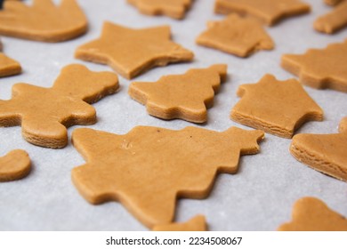 christmas gingerbread on a white parchment on a baking sheet