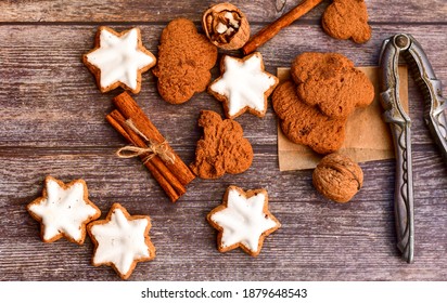 Christmas gingerbread star shaped   cookies and cinnamon sticks ,   on   wooden background with lights . Christmas  card background   - Powered by Shutterstock