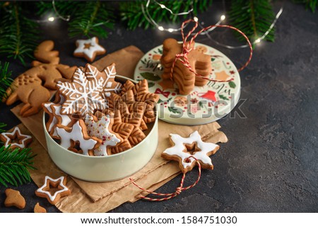 Christmas gingerbread stars cookies in a can on a dark background. Copy space.  Selective focus