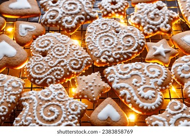 Christmas gingerbreads in the shapes of hearts and stars decorated with white icing, focus on the gingerbread cookie inside. Homemade, hand-decorated gingerbread cookies. - Powered by Shutterstock