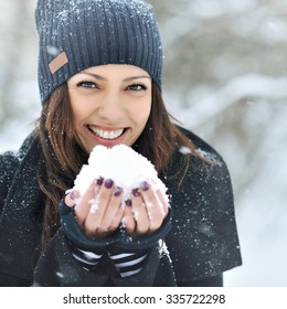 Christmas Girl Outdoor Portrait. Winter Woman Blowing Snow In A Park