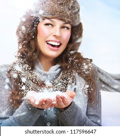 Christmas Girl.Winter Woman Blowing Snow