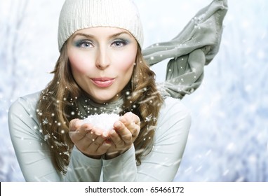 Christmas Girl.Winter Woman Blowing Snow