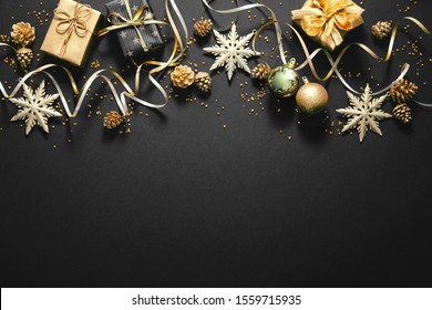 Christmas golden decoration with gift boxes on dark background. Template for greeting card - Powered by Shutterstock