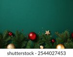 Christmas green background with red and gold baubles, pine branches, and stars. Xmas greeting card design, New Year banner template.