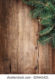 Christmas green fir tree on old grunge wooden board . New Years background