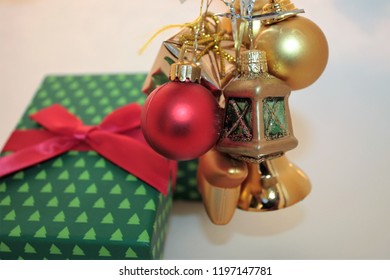 Christmas Green Gift Box, Christmas Presents With Gold Balls, Glass Ball With Rudolf Toy On Light Background