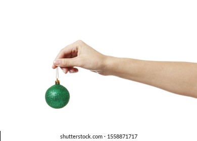Christmas green toy ball for the Christmas tree in hand isolated on a white background.