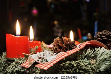 Christmas Green Tree And Candlelight. Beautiful Festive Background And Close Up. Dark And Light. Light all the candles on the Advent wreath, naming the candles aloud - hope, peace, joy, and love. - Powered by Shutterstock