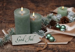 Christmas Greeting Card: Green Candles With Christmas Balls And The Inscription God Jul On A Sign. Swedish Inscription Means Merry Christmas.