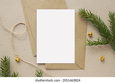 Christmas greeting card mockup, blank vertical notecard, postcard, craft paper envelopes, fir tree branches. - Powered by Shutterstock