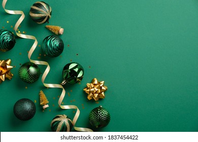 Christmas greeting card mockup. Elegant Xmas baubles and golden decorations on green background. Flat lay, top view. - Powered by Shutterstock