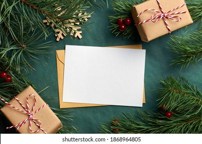 Christmas Greeting Card Mockup With Gift Boxes And Pine Tree Branches On Green Background