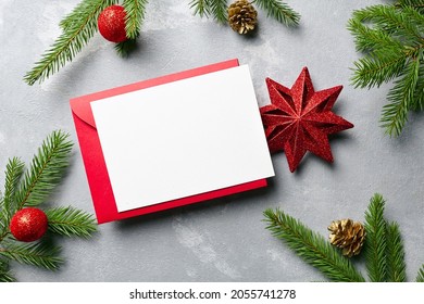 Christmas Greeting Or Invitation Card Mockup With Red Envelope And Festive Decorations