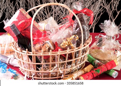 Christmas hamper basket with a chocolate Santa, cookies and a bottle of wine  - Shutterstock ID 335851658