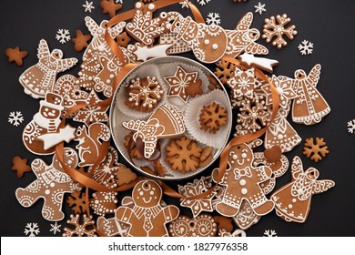 Christmas hand-painted gingerbread with icing and cookie box on black background, view from above. Holiday food, homemade baking, Christmas and New Year traditions. - Powered by Shutterstock