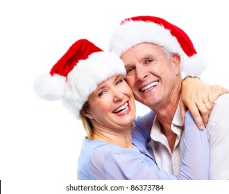 Christmas. Happy Senior Couple  With Santa Caps . Isolated Over White Background.