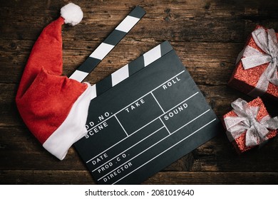 Christmas hat with film board cutout on wooden table