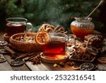 Christmas herbal tea with cinnamon, anise, and slices of dry citrus. Herbal tea with ingredients on a old wooden table.