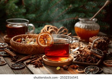 Christmas herbal tea with cinnamon, anise, and slices of dry citrus. Herbal tea with ingredients on a old wooden table. - Powered by Shutterstock