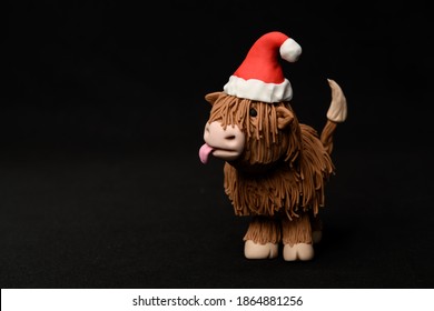 Christmas Highland Cow Sugar Fondant Model On A Black Background