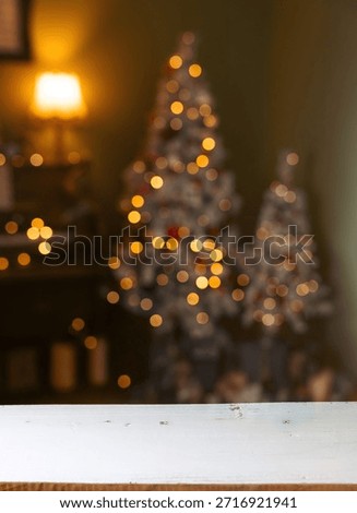 Christmas holiday background with empty rustic table over christmas bokeh background.