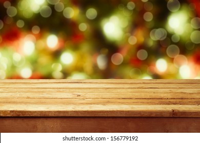 Christmas Holiday Background With Empty Wooden Deck Table Over Festive Bokeh. Ready For Product Montage