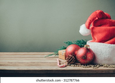 Christmas holiday background with Santa hat and decorations. Retro filter effect