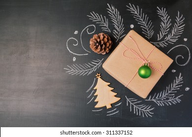 Christmas Holiday Gift On Chalkboard Background. View From Above With Copy Space