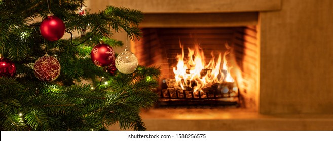 Christmas Holiday Home Background. Warm Cozy Burning Fireplace And Xmas Tree Decorated, Season Greetings Card Template, Banner