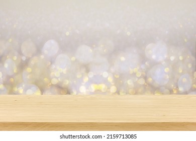 Christmas Holiday White And Golden Background With Empty Wooden Deck Table Over Winter Bokeh. Ready For Product Montage