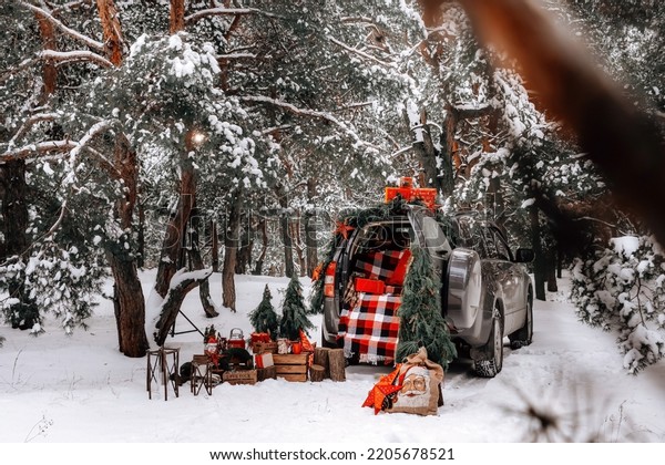 Christmas holidays with a family in a winter forest\
with gifts