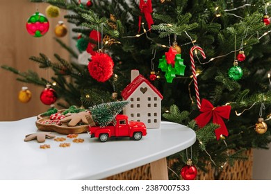 Christmas holidays. Little houses, toys and christmas decorations on the table next to the Christmas tree. Holiday Activity for Kids. Merry Christmas and Happy Holidays!  - Powered by Shutterstock