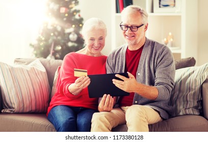 christmas, holidays and people concept - happy smiling senior couple with tablet pc computer and credit card shopping online at home - Powered by Shutterstock