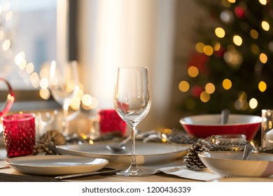 Christmas, Holidays And Table Setting Concept - Wine Glass And Tableware For Festive Dinner At Home