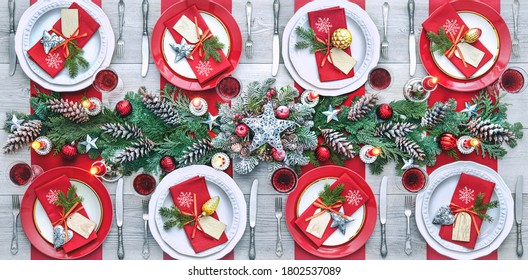 Christmas holidays table setting concept - wine glasses and tableware for festive dinner at home - Powered by Shutterstock